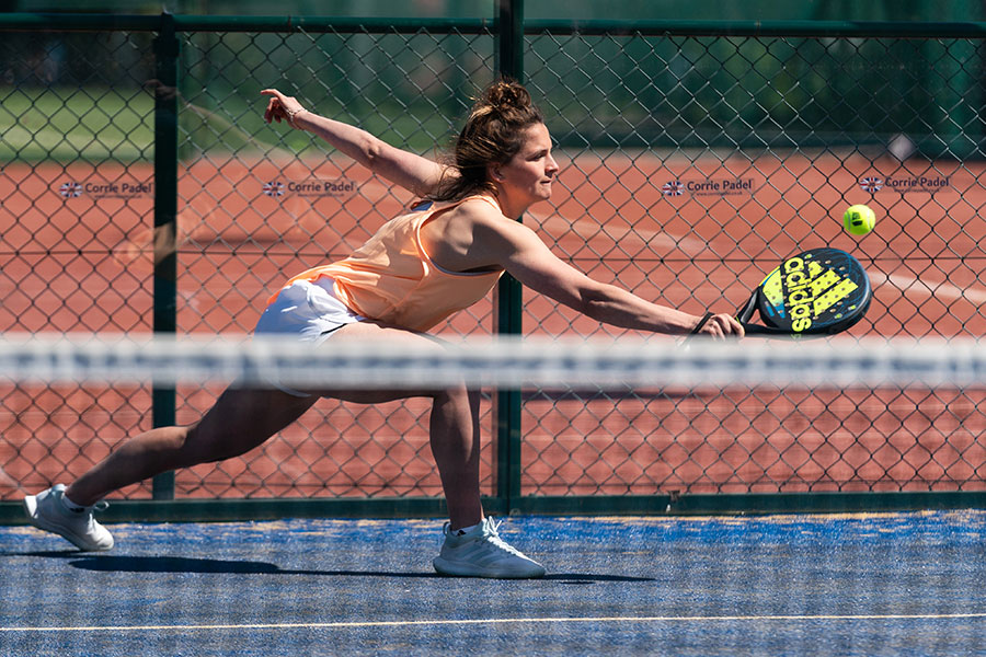 membership-padel-competition-doubles Woman taking part in a competitive padel match.